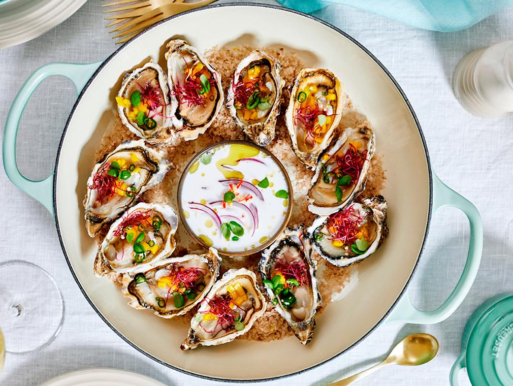 Oysters On A Bed Of Smoked Salt With Mango, Chilli And Green Oil